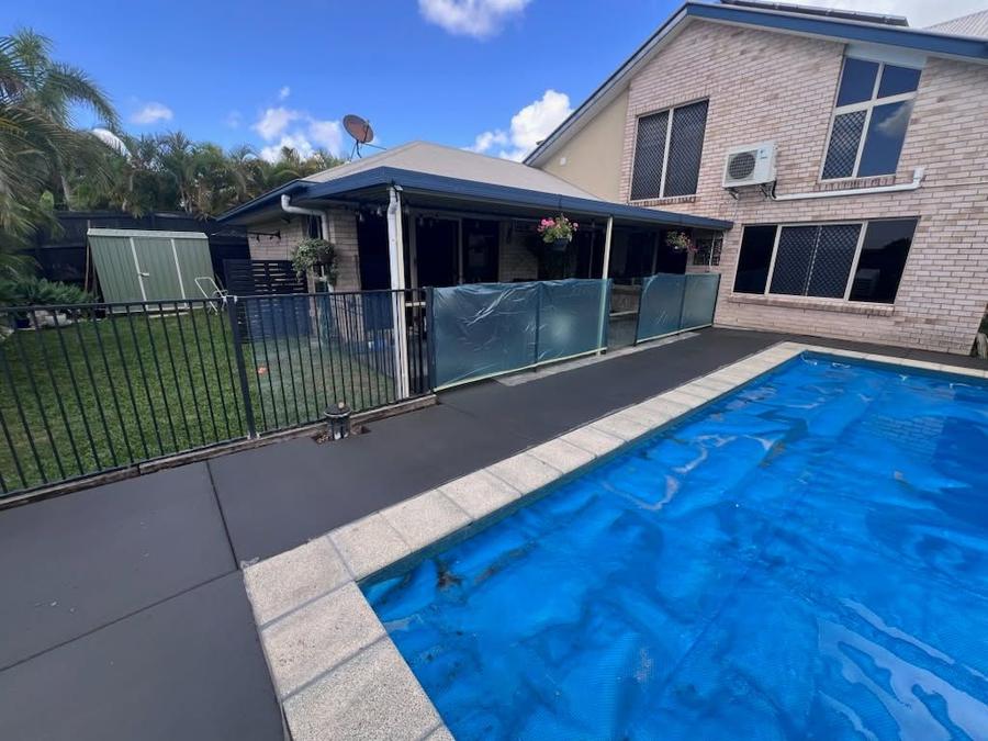 Charcoal concrete pool surround with pale coping